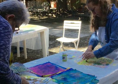 Painting custom textile arts during an Orvieto workshop.