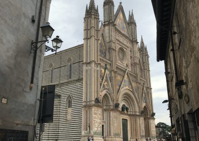 A stunning first look at the massive Duomo emerging between narrow city streets.