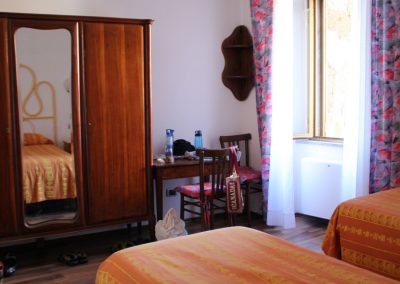 A modern hotel double room with a single bed and minimalist decor.