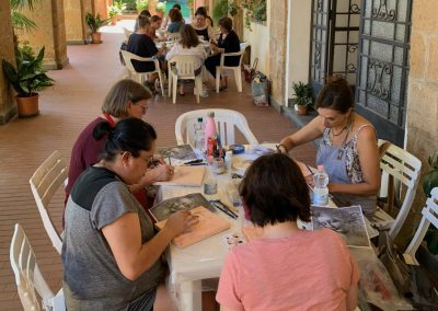 Art tour guests painting at an outdoor Orvieto workshop.
