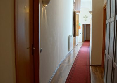 A charming interior hallway in an Italian boutique accommodation with stone walls.